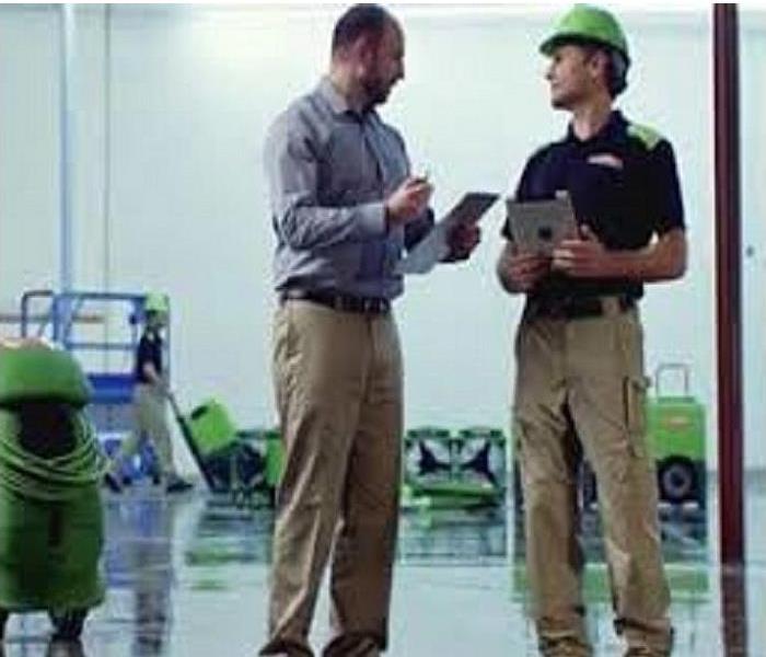 SERVPRO® Production Manager reviews the Scope of Work for a commercial water loss with the Owner of the property.