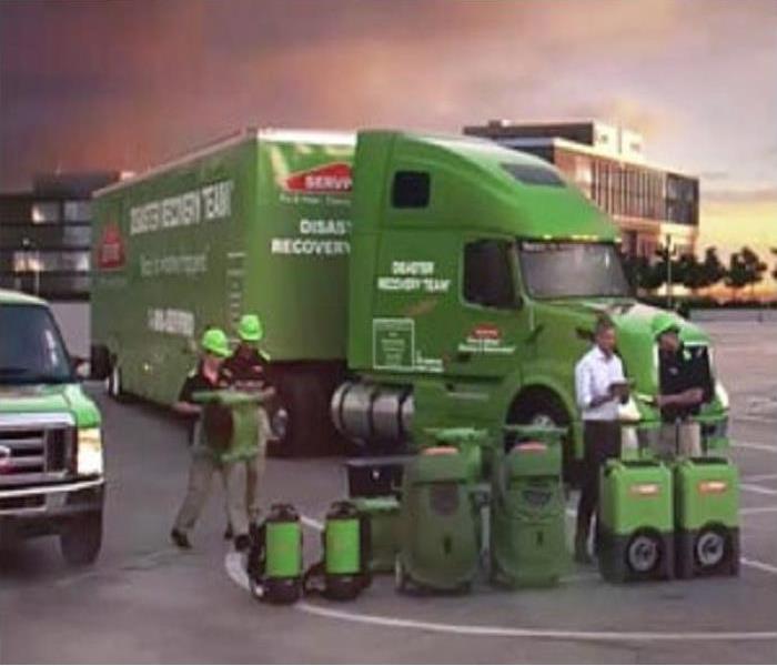 SERVPRO® Technicians load several equipment unto a van and a trailer truck in preparation for a large loss.