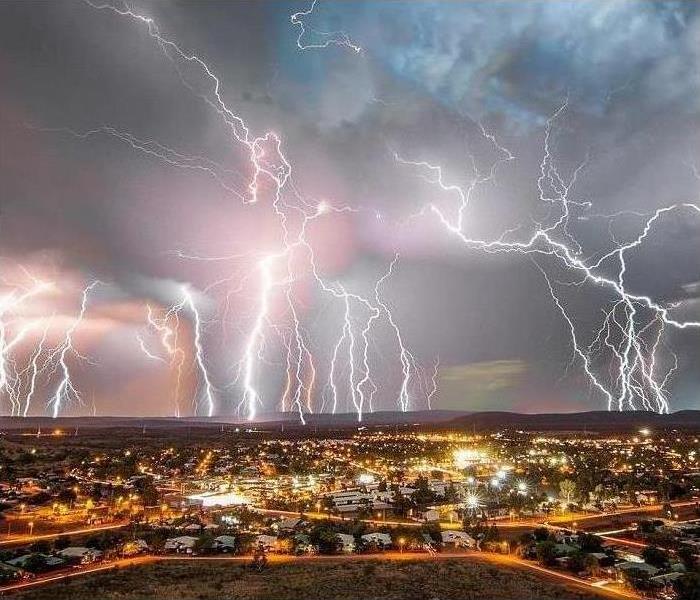 Lightning storm in the sky overlooks the entire city.